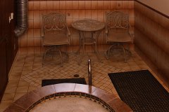 Sunken Tiled Hot Tub and Two Chairs at Clover Creek Inn